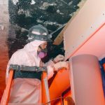 Worker removing asbestos