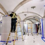 Worker restoring intricate architechture